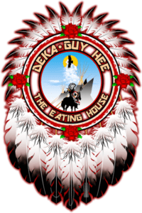 Illustration of a crest featuring feathers, flowers, and a central circle with text "Deka Guy Hee" surrounding an image of a figure in traditional Native American headdress.